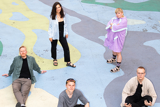 Young film makers in group photo with colourful background.